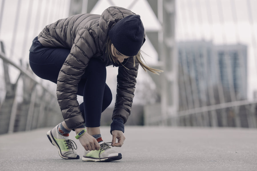 Athlete tying running shoes