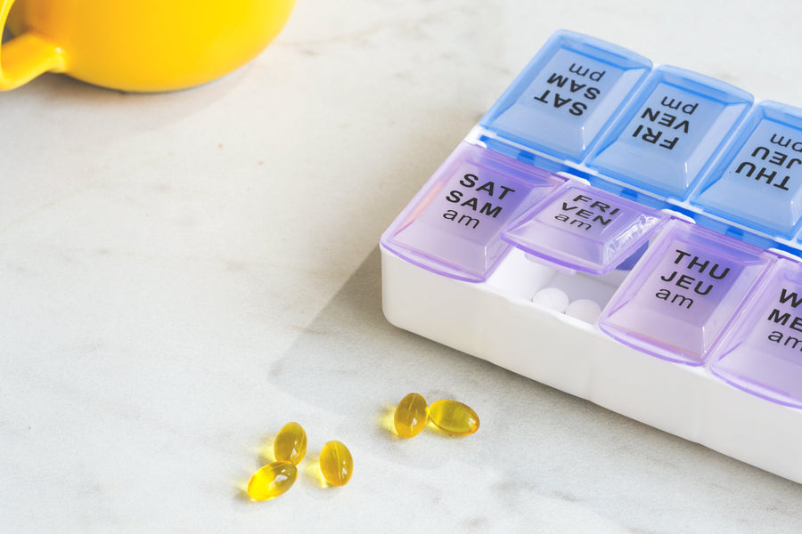 Pills next to pill box