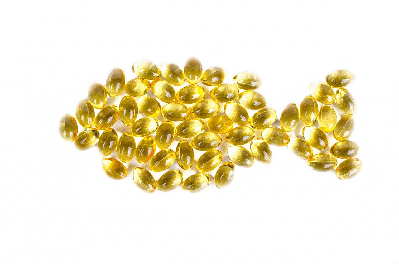 Fish oil pills arranged in the shape of a fish