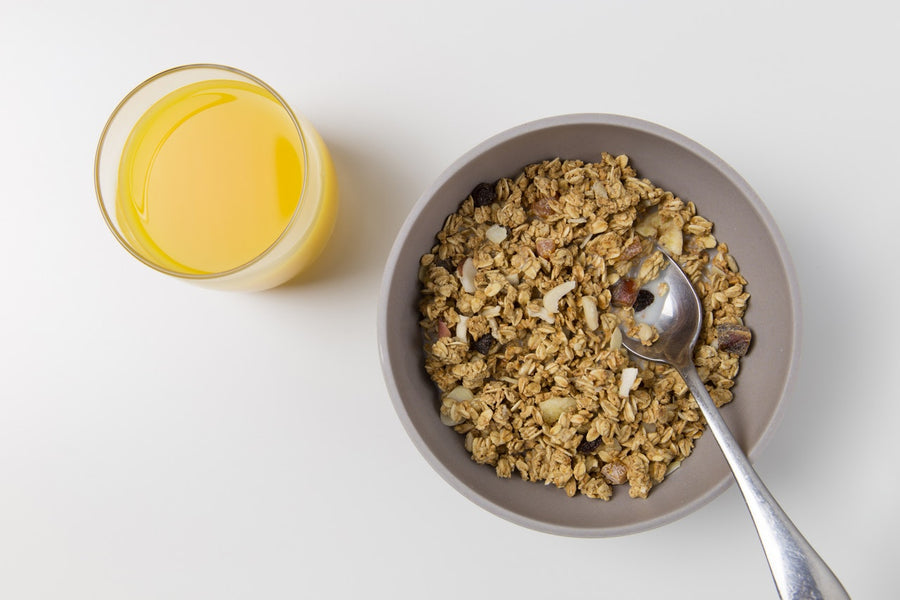 Glass of orange juice and a bowl of cereal