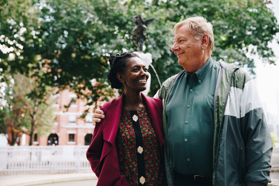 Two seniors smiling at the park