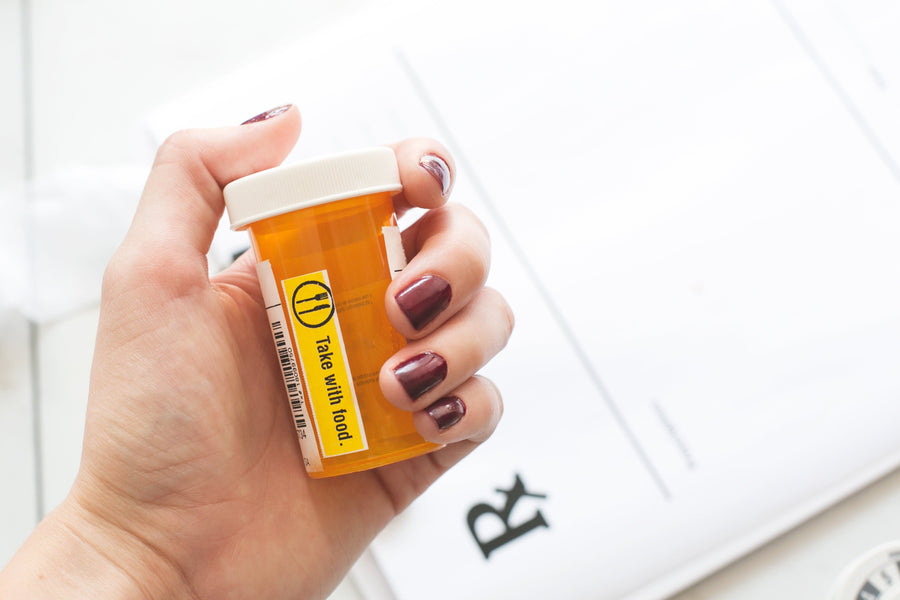 Hand holding prescription bottle